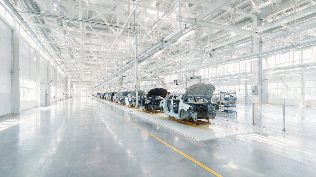 New cars rolling off a bright assembly hall line in Slovakia