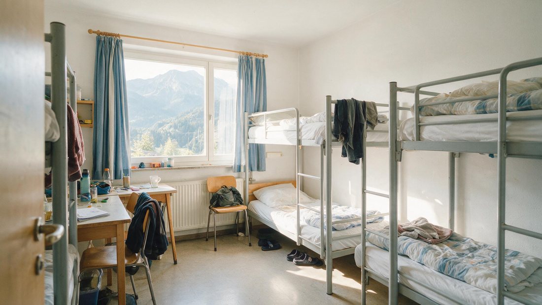 Bright staff room with bunk beds and mountain light through the window